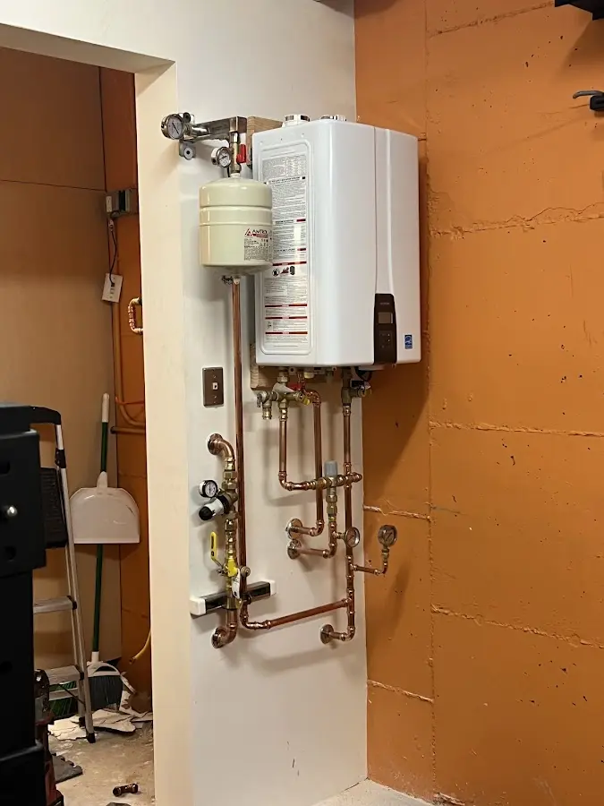Plumbing technician inspecting water heater connections in Valdosta